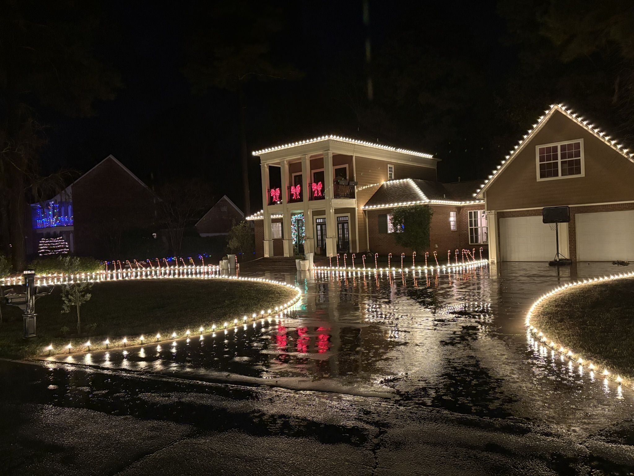 Home decorated with Christmas lights at night