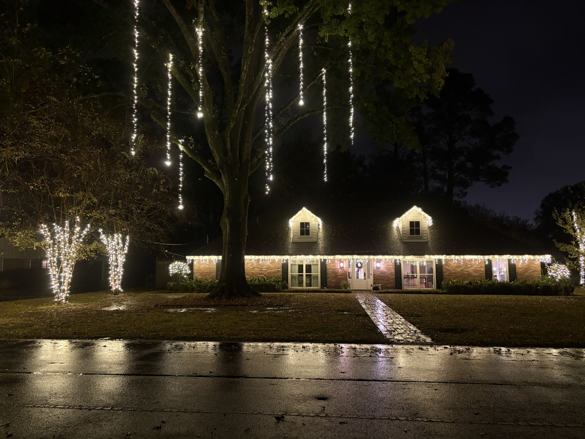 Home decorated with Christmas lights at night
