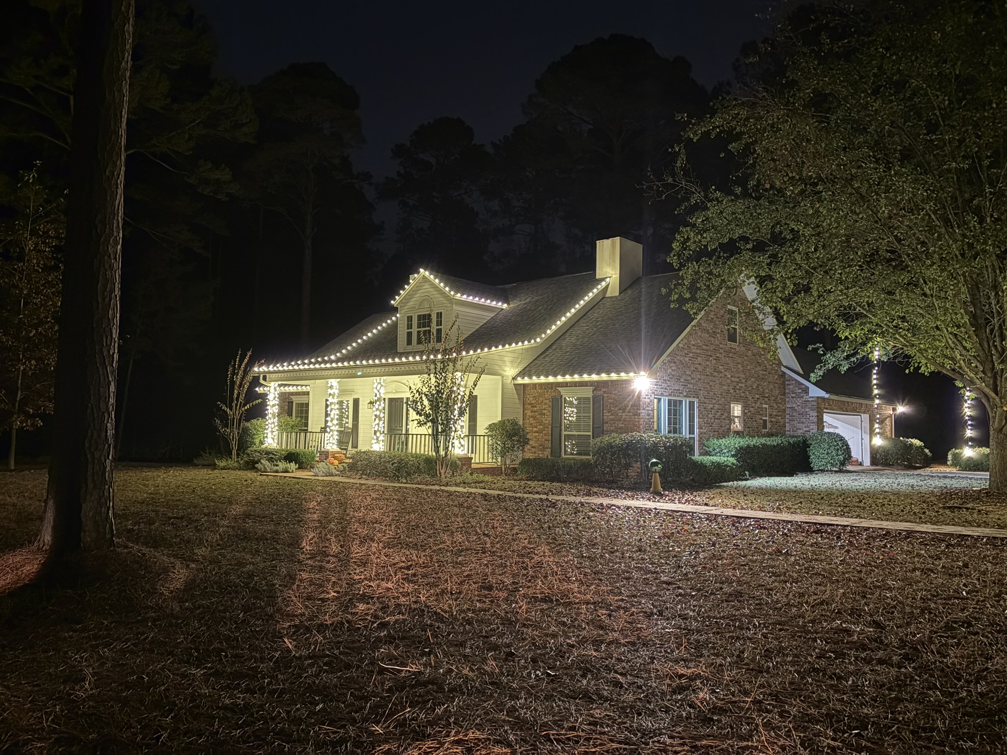 Home decorated with Christmas lights at night